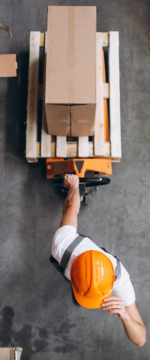 young-man-working-at-a-warehouse-with-boxes-scaled
